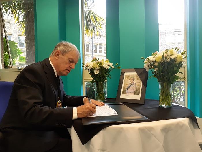 • Councillor Sibley, Chairman of Cherwell District Council is pictured signing the book of condolence