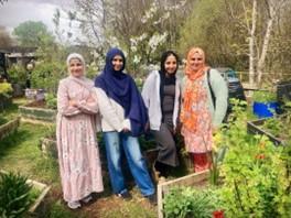 Young women standing in a community garden