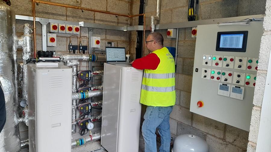 a member of staff is using a laptop to monitor the electrical supply at the depot