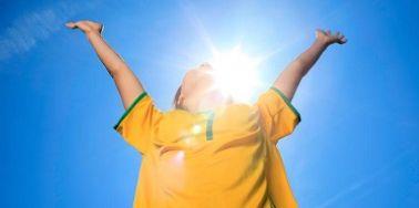 boy arms raised yellow tshirt