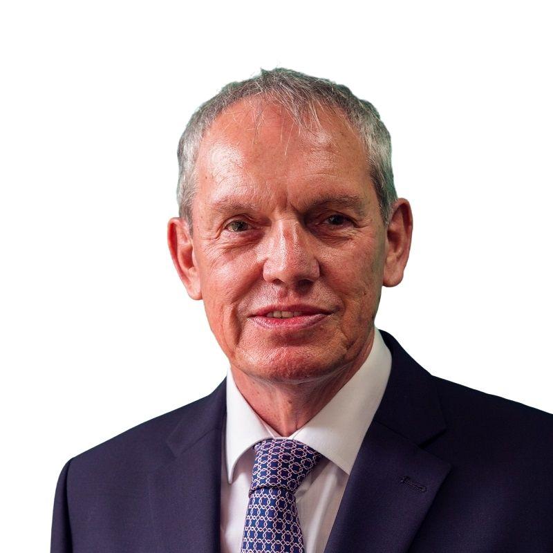 A head and shoulders portrait of Cllr Sibley who is dressed in a jacket and tie and smiling at the camera.