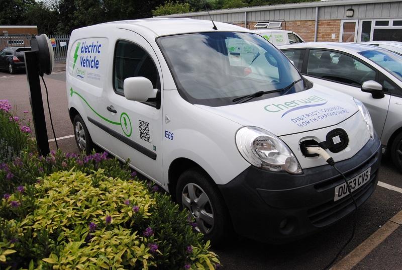 An electric van is being charged up at the depot