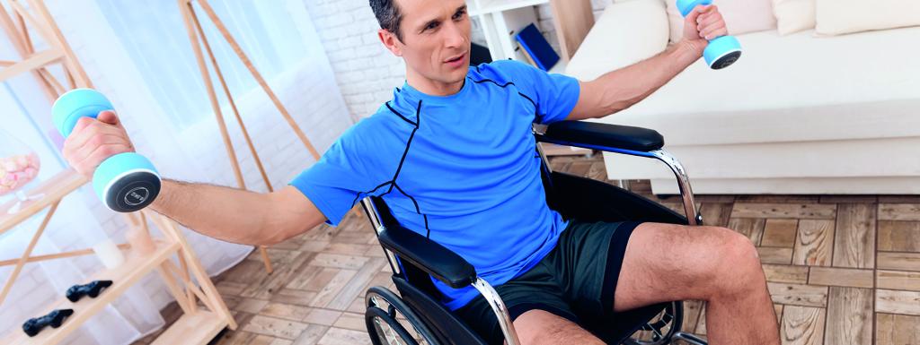 Man lifting weights in a wheelchair