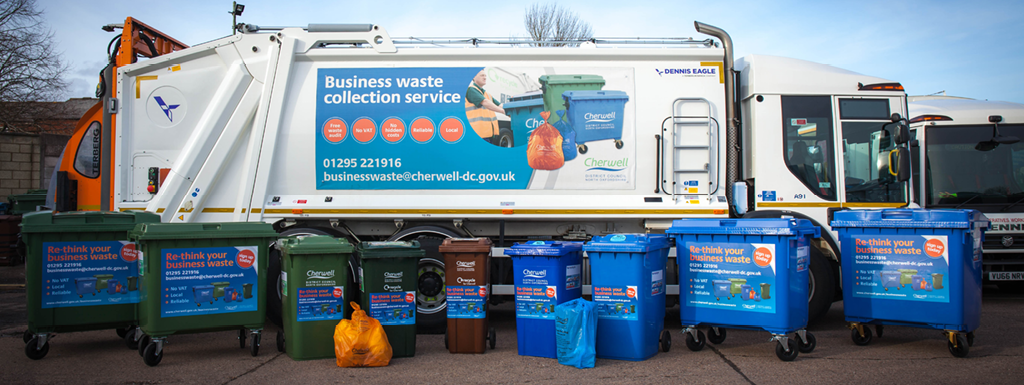 Cherwell refuse collection vehicle with a selection of commercial waste and recycling bins