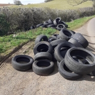tyres are strewn across a layby