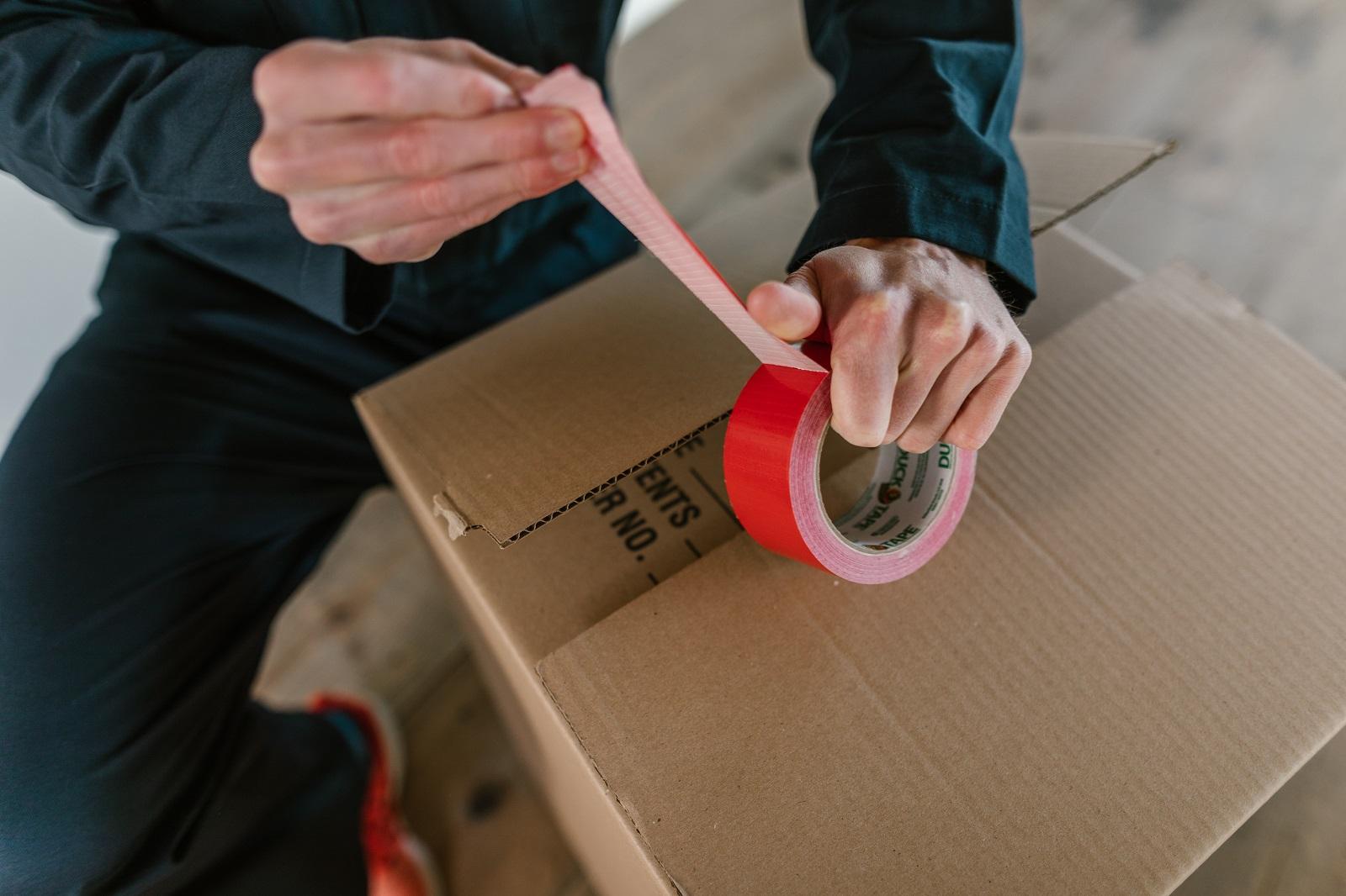 packing up a box with red tape